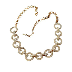 Vintage gold tone necklace with interlocking clear rhinestone circle links and lobster clasp.