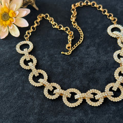 Vintage gold tone necklace with interlocking clear rhinestone circle links and lobster clasp.