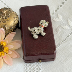 Vintage gold‑tone dog brooch with clear and black pavé rhinestones and a red enamel collar.
