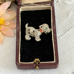 Vintage gold‑tone dog brooch with clear and black pavé rhinestones and a red enamel collar.