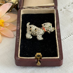 Vintage gold‑tone dog brooch with clear and black pavé rhinestones and a red enamel collar.