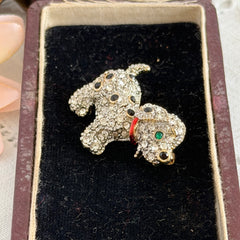 Vintage gold‑tone dog brooch with clear and black pavé rhinestones and a red enamel collar.