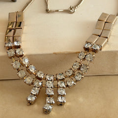 Vintage gold‑tone necklace with rectangular links and a clear rhinestone fringe.