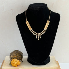 Vintage gold‑tone necklace with rectangular links and a clear rhinestone fringe.