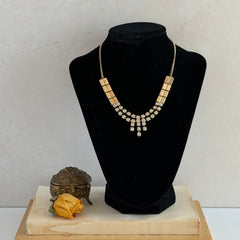 Vintage gold‑tone necklace with rectangular links and a clear rhinestone fringe.