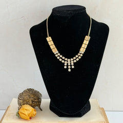 Vintage gold‑tone necklace with rectangular links and a clear rhinestone fringe.