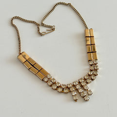 Vintage gold‑tone necklace with rectangular links and a clear rhinestone fringe.