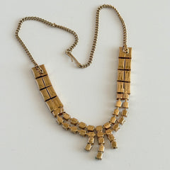 Vintage gold‑tone necklace with rectangular links and a clear rhinestone fringe.
