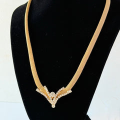 Vintage 1960s gold tone mesh necklace with clear rhinestone centerpiece, shown from multiple angles on display.