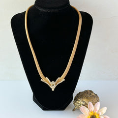 Vintage 1960s gold tone mesh necklace with clear rhinestone centerpiece, shown from multiple angles on display.