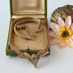 Vintage 1960s gold tone mesh necklace with clear rhinestone centerpiece, shown from multiple angles on display.