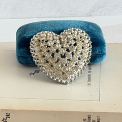 Vintage silver‑tone heart brooch with clear rhinestones in a pavé heart design.