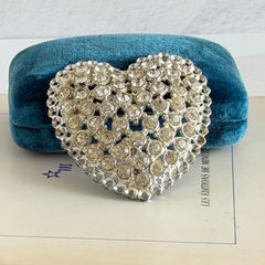 Vintage silver‑tone heart brooch with clear rhinestones in a pavé heart design.