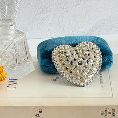 Vintage silver‑tone heart brooch with clear rhinestones in a pavé heart design.