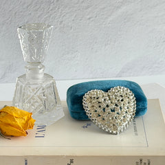 Vintage silver‑tone heart brooch with clear rhinestones in a pavé heart design.