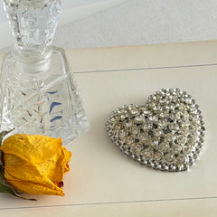 Vintage silver‑tone heart brooch with clear rhinestones in a pavé heart design.