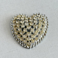 Vintage silver‑tone heart brooch with clear rhinestones in a pavé heart design.