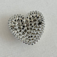 Vintage silver‑tone heart brooch with clear rhinestones in a pavé heart design.