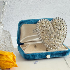 Vintage silver‑tone heart brooch with clear rhinestones in a pavé heart design.
