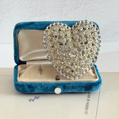 Vintage silver‑tone heart brooch with clear rhinestones in a pavé heart design.
