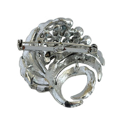 Vintage silver tone swirl leaf brooch with clear rhinestone cluster, textured metal, 1970s–1980s.