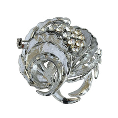 Vintage silver tone swirl leaf brooch with clear rhinestone cluster, textured metal, 1970s–1980s.