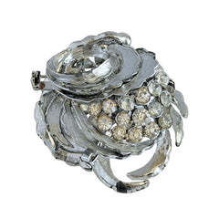 Vintage silver tone swirl leaf brooch with clear rhinestone cluster, textured metal, 1970s–1980s.