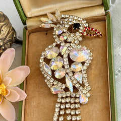 Vintage gold‑tone cockatoo brooch with AB rhinestones and tassel tail, oversized statement bird pin.