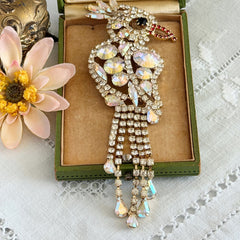 Vintage gold‑tone cockatoo brooch with AB rhinestones and tassel tail, oversized statement bird pin.