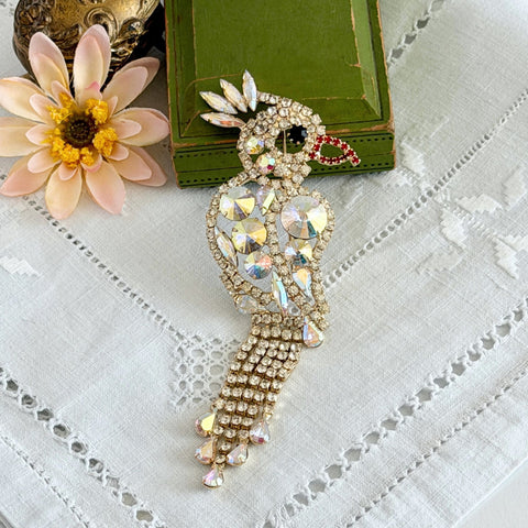 Vintage gold‑tone cockatoo brooch with AB rhinestones and tassel tail, oversized statement bird pin.
