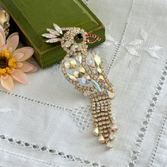 Vintage gold‑tone cockatoo brooch with AB rhinestones and tassel tail, oversized statement bird pin.