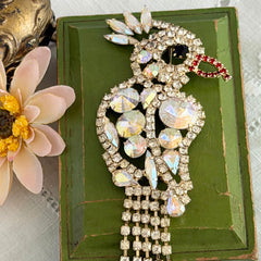 Vintage gold‑tone cockatoo brooch with AB rhinestones and tassel tail, oversized statement bird pin.