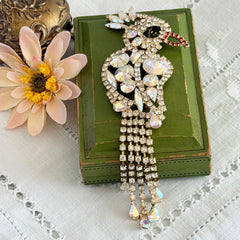 Vintage gold‑tone cockatoo brooch with AB rhinestones and tassel tail, oversized statement bird pin.