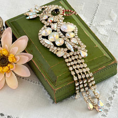 Vintage gold‑tone cockatoo brooch with AB rhinestones and tassel tail, oversized statement bird pin.