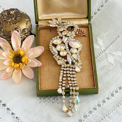 Vintage gold‑tone cockatoo brooch with AB rhinestones and tassel tail, oversized statement bird pin.