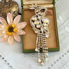 Vintage gold‑tone cockatoo brooch with AB rhinestones and tassel tail, oversized statement bird pin.