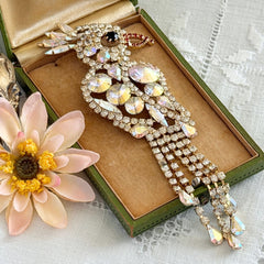 Vintage gold‑tone cockatoo brooch with AB rhinestones and tassel tail, oversized statement bird pin.
