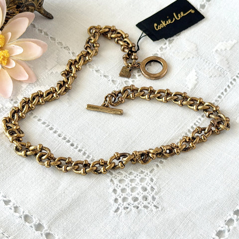 Vintage Cookie Lee gold‑tone cable chain necklace with textured links and toggle clasp, shown in close‑up to display design and condition.