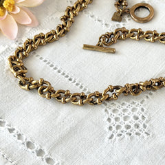 Vintage Cookie Lee gold‑tone cable chain necklace with textured links and toggle clasp, shown in close‑up to display design and condition.