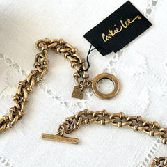 Vintage Cookie Lee gold‑tone cable chain necklace with textured links and toggle clasp, shown in close‑up to display design and condition.