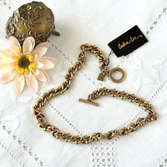 Vintage Cookie Lee gold‑tone cable chain necklace with textured links and toggle clasp, shown in close‑up to display design and condition.