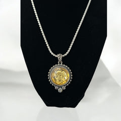 Vintage Cookie Lee necklace featuring a faceted yellow Lucite pendant with a rose intaglio in an ornate silver tone setting, hanging from a thick serpentine chain.
