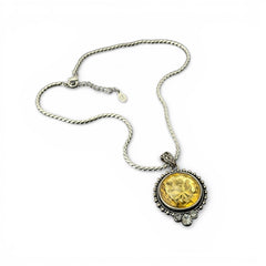 Vintage Cookie Lee necklace featuring a faceted yellow Lucite pendant with a rose intaglio in an ornate silver tone setting, hanging from a thick serpentine chain.