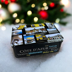 French holiday tin gift box with two mini Marseille soaps and a lavender sachet nestled in crinkle paper, available in Paris, Nice, or Côte d’Azur designs — a festive surprise gift from France.