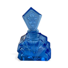 Vintage Czech Art Deco sapphire blue fan‑shaped perfume bottle with geometric stopper and frosted intaglio floral dauber, shown in styled settings that highlight its faceted design, vibrant color, and collectible craftsmanship.