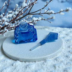 Vintage Czech Art Deco sapphire blue fan‑shaped perfume bottle with geometric stopper and frosted intaglio floral dauber, shown in styled settings that highlight its faceted design, vibrant color, and collectible craftsmanship.