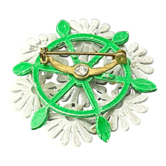 Vintage 1960s enamel daisy brooch with white petals, orange centers, and green leaves in a round floral cluster. Silver-toned finish, 2-inch diameter, in very good condition.