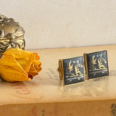 Vintage Amita Japan damascene square cufflinks with gold and silver bamboo motif on black enamel, signed on the back, displayed on a neutral surface.