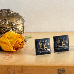 Vintage Amita Japan damascene square cufflinks with gold and silver bamboo motif on black enamel, signed on the back, displayed on a neutral surface.