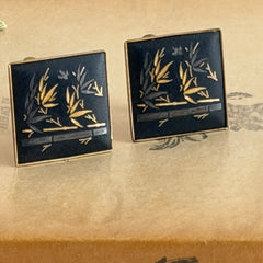Vintage Amita Japan damascene square cufflinks with gold and silver bamboo motif on black enamel, signed on the back, displayed on a neutral surface.